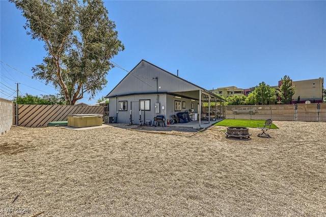 80 E Texas Ave, Henderson, NV 89015 - back of house featuring an outdoor fire pit, a patio, a fenced backyard, and a hot tub