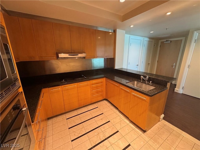 2700 Las Vegas Blvd Unit 2811, Las Vegas, NV 89109 - kitchen featuring a sink, stainless steel oven, a peninsula, recessed lighting, and under cabinet range hood