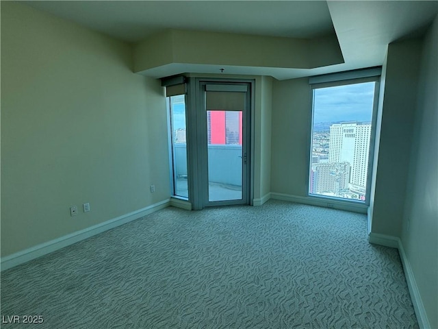 2700 Las Vegas Blvd Unit 2811, Las Vegas, NV 89109 - spare room featuring light colored carpet, plenty of natural light, and baseboards