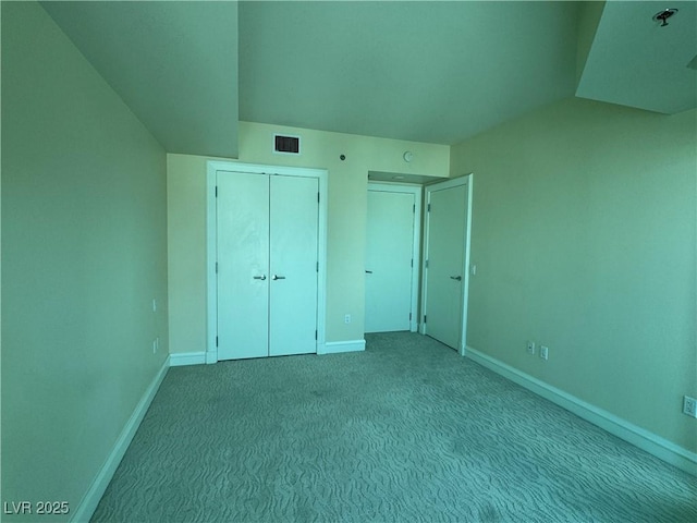 2700 Las Vegas Blvd Unit 2811, Las Vegas, NV 89109 - unfurnished bedroom with baseboards, carpet, a closet, and lofted ceiling