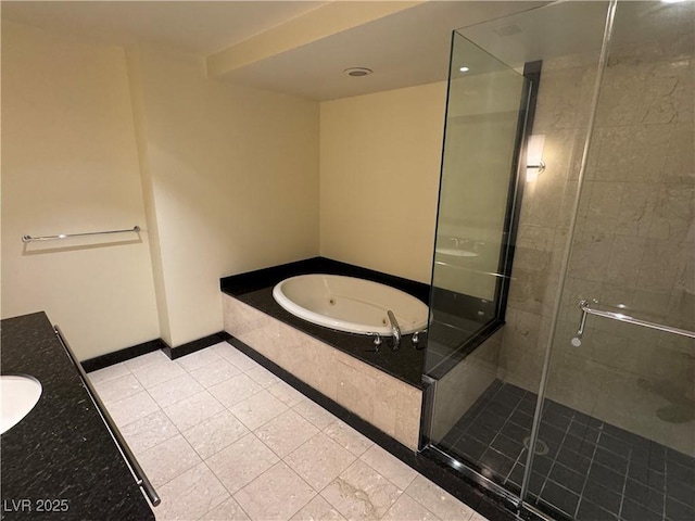 2700 Las Vegas Blvd Unit 2811, Las Vegas, NV 89109 - bathroom with a tub with jets, a stall shower, tile patterned floors, vanity, and baseboards