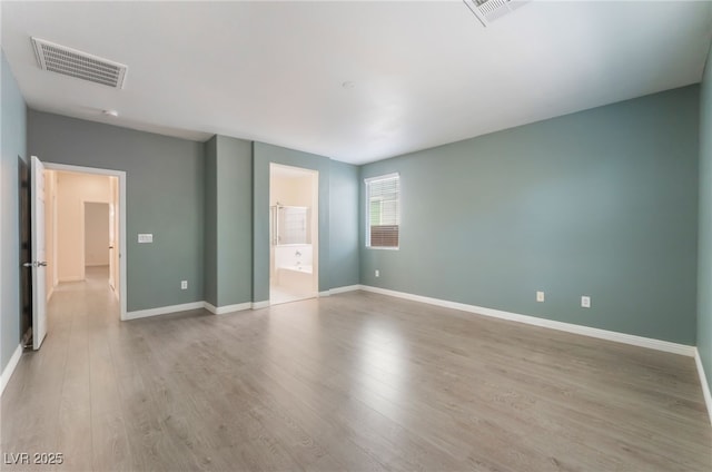 908 Cypress Gold Ct, North Las Vegas, NV 89031 - unfurnished bedroom with light wood-style floors, baseboards, and ensuite bath