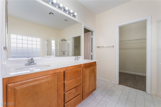 908 Cypress Gold Ct, North Las Vegas, NV 89031 - bathroom with a shower stall, a spacious closet, and double vanity