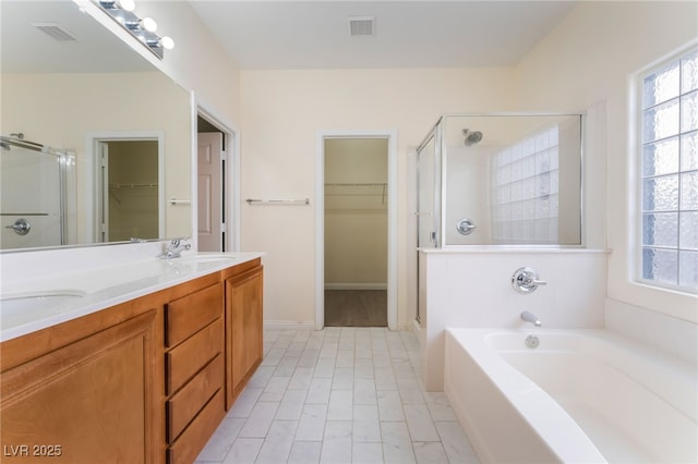 908 Cypress Gold Ct, North Las Vegas, NV 89031 - full bath with a shower stall, a walk in closet, double vanity, and a bath