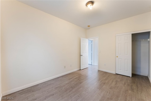 908 Cypress Gold Ct, North Las Vegas, NV 89031 - unfurnished bedroom with light wood finished floors, baseboards, and a closet