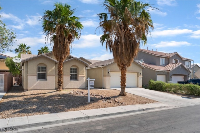 908 Cypress Gold Ct, North Las Vegas, NV 89031 - mediterranean / spanish home featuring stucco siding, a garage, concrete driveway, and a tile roof
