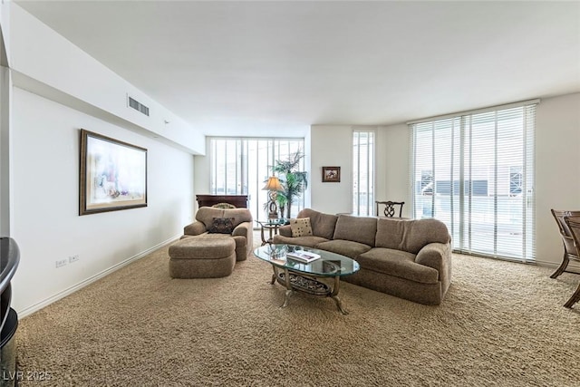 2877 Paradise Rd Unit 906, Las Vegas, NV 89109 - living area with carpet floors, baseboards, and floor to ceiling windows