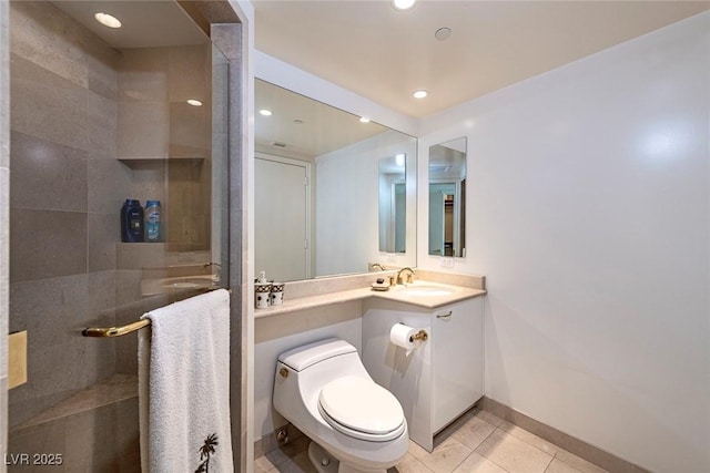 2877 Paradise Rd Unit 906, Las Vegas, NV 89109 - bathroom featuring vanity, baseboards, tiled shower, toilet, and tile patterned flooring