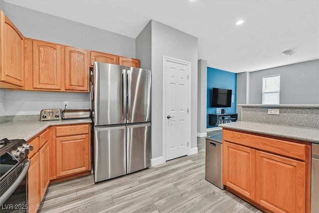 9010 Wine Cellar Ave, Las Vegas, NV 89148 - kitchen featuring stainless steel appliances, light countertops, light wood-style flooring, and baseboards