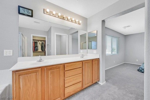 9010 Wine Cellar Ave, Las Vegas, NV 89148 - bathroom featuring double vanity, baseboards, a shower with door, and a walk in closet