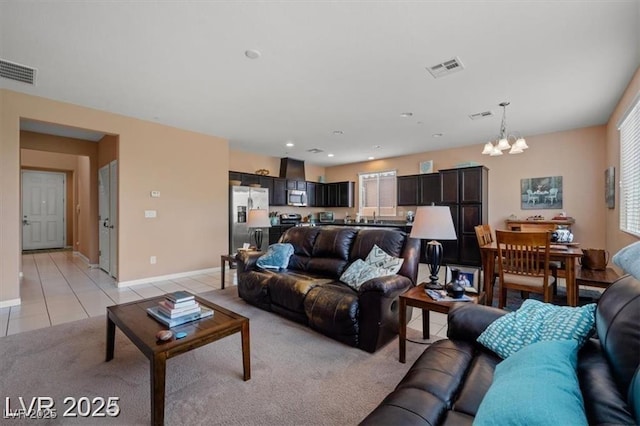 33 Via Di Mello, Henderson, NV 89011 - living room featuring a chandelier, baseboards, light tile patterned floors, and light carpet