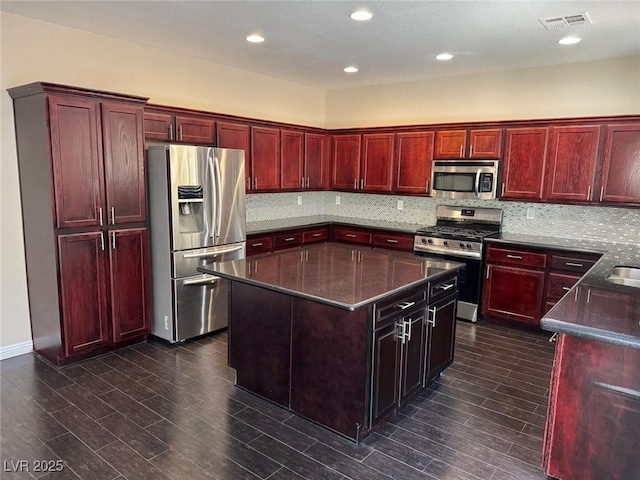 10118 Farmington Hall Ct, Las Vegas, NV 89129 - kitchen with appliances with stainless steel finishes, reddish brown cabinets, backsplash, and recessed lighting
