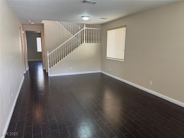 10118 Farmington Hall Ct, Las Vegas, NV 89129 - unfurnished living room with stairs, baseboards, dark wood finished floors, and plenty of natural light