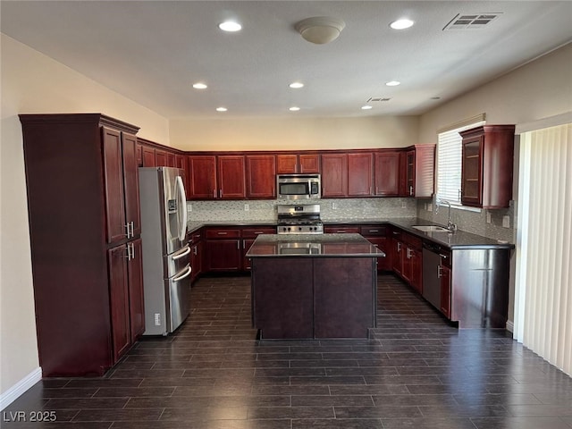 10118 Farmington Hall Ct, Las Vegas, NV 89129 - kitchen featuring appliances with stainless steel finishes, dark brown cabinets, dark countertops, a sink, and recessed lighting