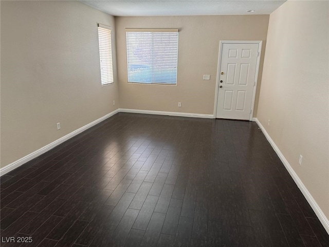 10118 Farmington Hall Ct, Las Vegas, NV 89129 - spare room featuring dark wood finished floors and baseboards