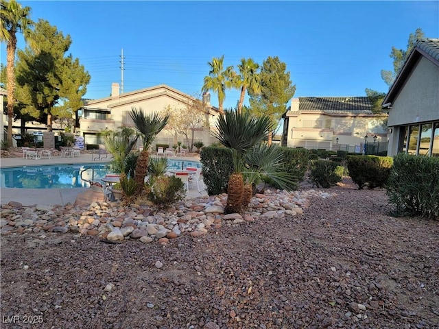 5710 E Tropicana Ave Unit 1172, Las Vegas, NV 89122 - exterior space with a community pool, a patio, and stucco siding