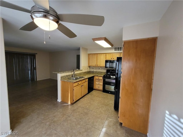 5710 E Tropicana Ave Unit 1172, Las Vegas, NV 89122 - kitchen with black appliances, a sink, a peninsula, ceiling fan, and light tile patterned floors