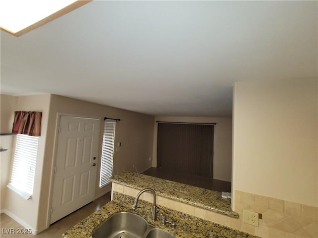 5710 E Tropicana Ave Unit 1172, Las Vegas, NV 89122 - kitchen featuring a sink, light stone counters, and baseboards