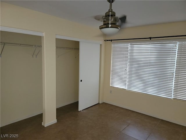 5710 E Tropicana Ave Unit 1172, Las Vegas, NV 89122 - unfurnished bedroom featuring two closets and baseboards