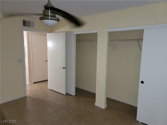 5710 E Tropicana Ave Unit 1172, Las Vegas, NV 89122 - unfurnished bedroom featuring two closets, tile patterned floors, and baseboards