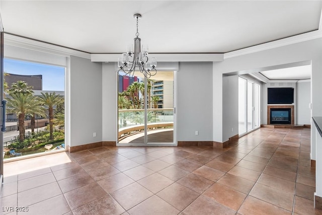 2857 Paradise Rd Unit 301, Las Vegas, NV 89109 - tiled spare room with a chandelier, ornamental molding, a fireplace, and baseboards