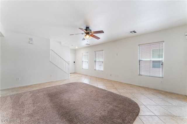 8872 Perfect Diamond Ct, Las Vegas, NV 89129 - unfurnished living room featuring light tile patterned floors, ceiling fan, stairway, and baseboards