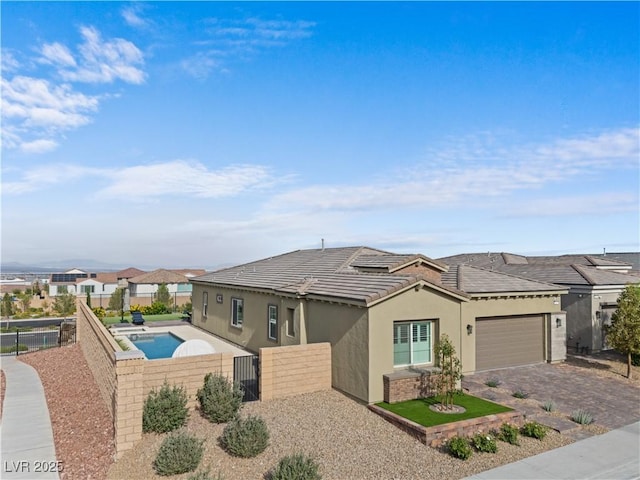 8668 Hartmont St, Las Vegas, NV 89166 - single story home with stucco siding, an attached garage, a tile roof, and driveway
