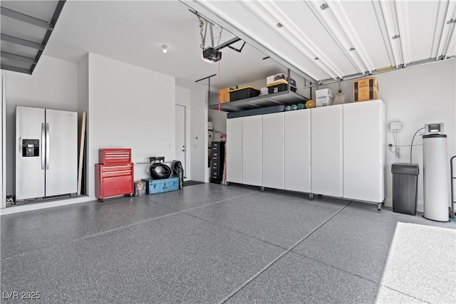 8668 Hartmont St, Las Vegas, NV 89166 - garage featuring stainless steel fridge and a garage door opener