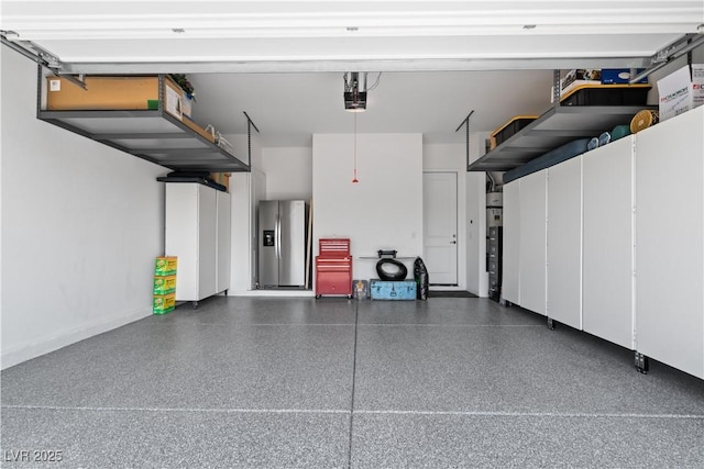 8668 Hartmont St, Las Vegas, NV 89166 - garage with stainless steel fridge with ice dispenser and a garage door opener