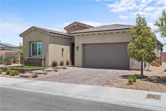 8668 Hartmont St, Las Vegas, NV 89166 - view of front of home featuring stucco siding, driveway, a garage, and a tiled roof