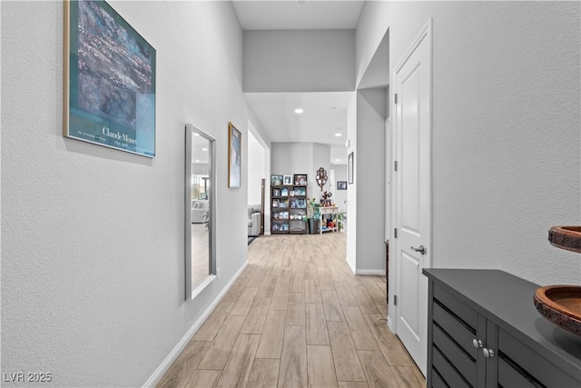 8668 Hartmont St, Las Vegas, NV 89166 - corridor with light wood finished floors, baseboards, recessed lighting, and a textured wall