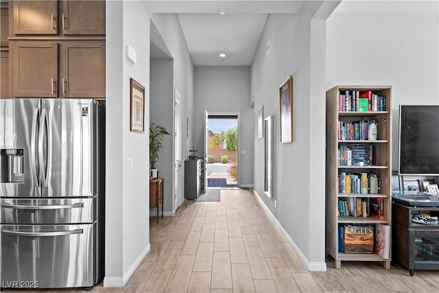 8668 Hartmont St, Las Vegas, NV 89166 - hallway with baseboards and light wood-style flooring
