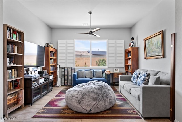 8668 Hartmont St, Las Vegas, NV 89166 - living room featuring a ceiling fan and wood finished floors