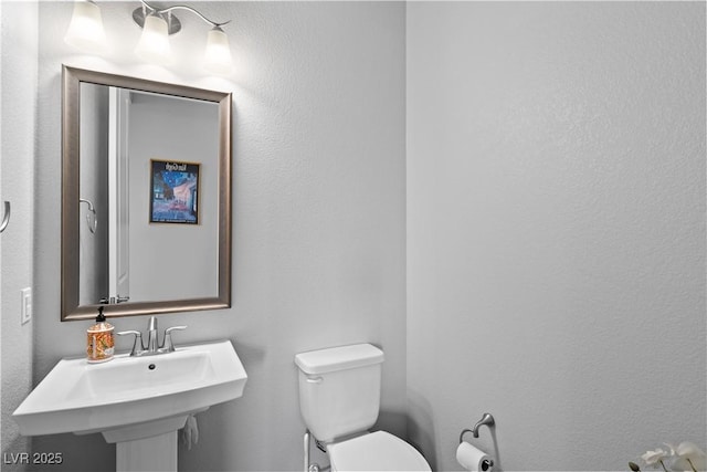 8668 Hartmont St, Las Vegas, NV 89166 - half bathroom featuring toilet and a sink