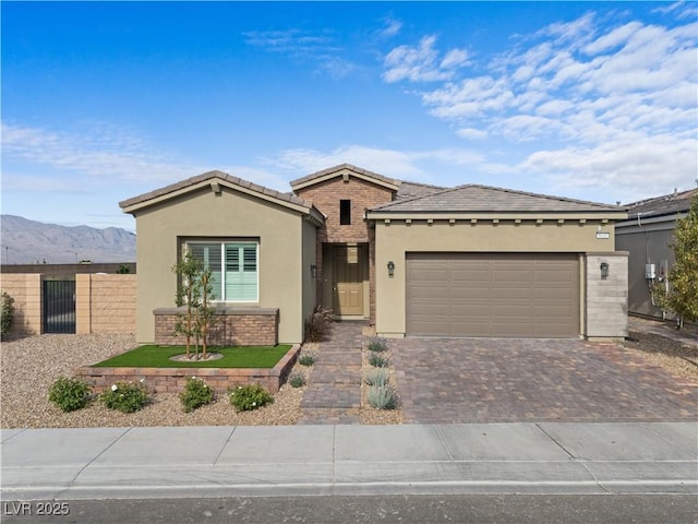 8668 Hartmont St, Las Vegas, NV 89166 - ranch-style house with stucco siding, driveway, a garage, a mountain view, and a tiled roof