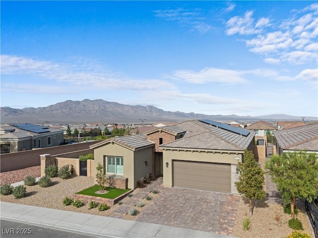 8668 Hartmont St, Las Vegas, NV 89166 - ranch-style house with stucco siding, a mountain view, an attached garage, decorative driveway, and a tile roof