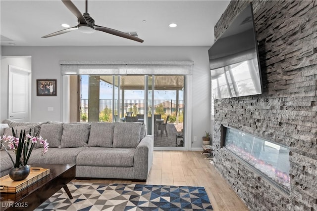 8668 Hartmont St, Las Vegas, NV 89166 - living area with plenty of natural light, a fireplace, light wood-style flooring, recessed lighting, and a ceiling fan