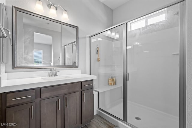 8668 Hartmont St, Las Vegas, NV 89166 - full bathroom featuring vanity, a shower stall, and wood finished floors