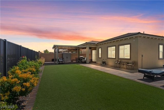 8668 Hartmont St, Las Vegas, NV 89166 - back of house at dusk featuring a patio area and stucco siding