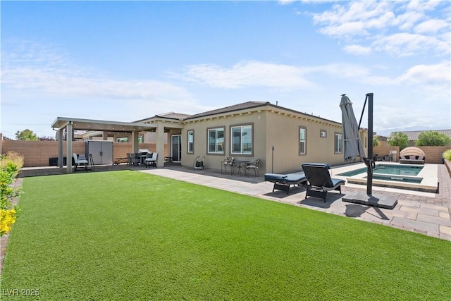 8668 Hartmont St, Las Vegas, NV 89166 - back of property featuring an in-ground hot tub, a patio area, and stucco siding