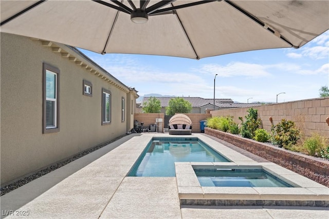 8668 Hartmont St, Las Vegas, NV 89166 - view of swimming pool with an in-ground hot tub, a fenced backyard, and a patio area