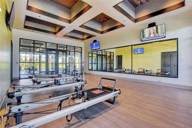 8668 Hartmont St, Las Vegas, NV 89166 - exercise room with wood finished floors, baseboards, coffered ceiling, beam ceiling, and french doors