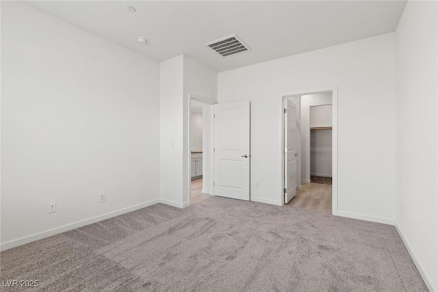 6731 Lotus Vista Ct, Las Vegas, NV 89156 - unfurnished bedroom with light colored carpet, baseboards, and a spacious closet