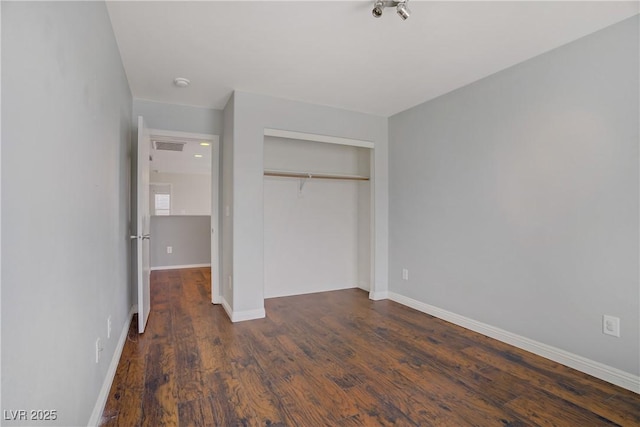 9190 Wine Cellar Ave, Las Vegas, NV 89148 - unfurnished bedroom with a closet, baseboards, and dark wood-style flooring