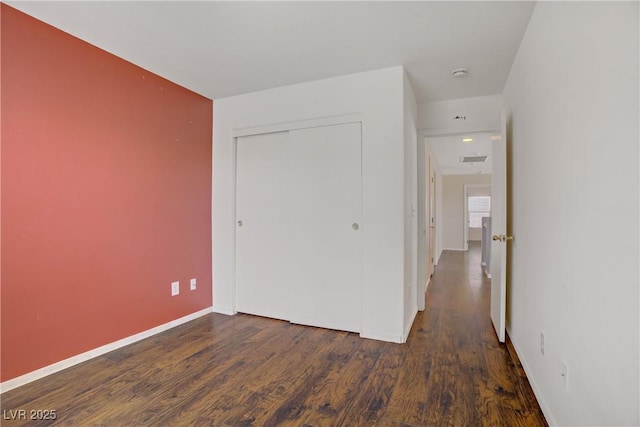 9190 Wine Cellar Ave, Las Vegas, NV 89148 - unfurnished bedroom with baseboards, wood finished floors, and a closet