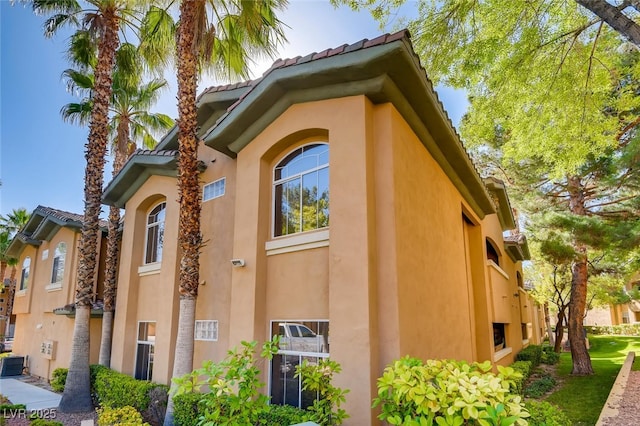 1713 Sky Of Red Dr Unit 203, Las Vegas, NV 89128 - view of property exterior with stucco siding and central AC