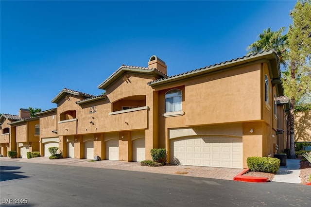 1713 Sky Of Red Dr Unit 203, Las Vegas, NV 89128 - view of property featuring cooling unit and a garage