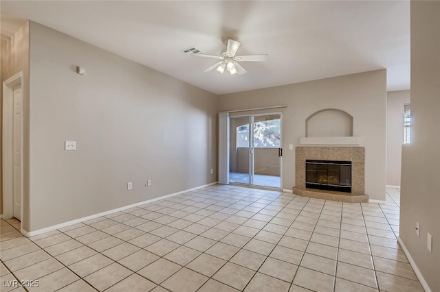 1713 Sky Of Red Dr Unit 203, Las Vegas, NV 89128 - unfurnished living room with ceiling fan, light tile patterned flooring, a high end fireplace, and baseboards
