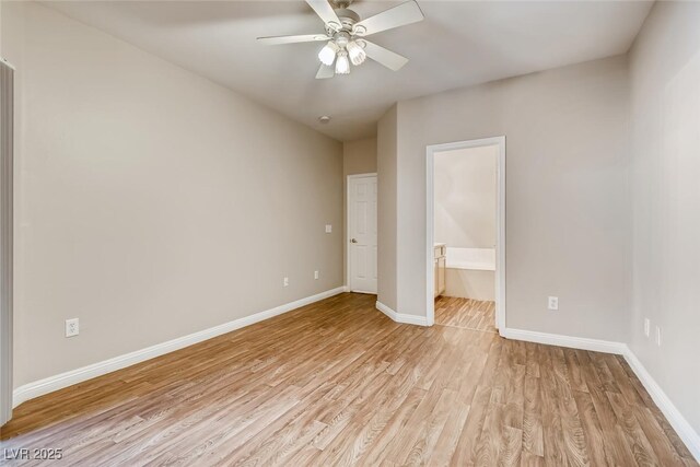 1713 Sky Of Red Dr Unit 203, Las Vegas, NV 89128 - unfurnished bedroom with light wood-type flooring, baseboards, ensuite bath, and a ceiling fan