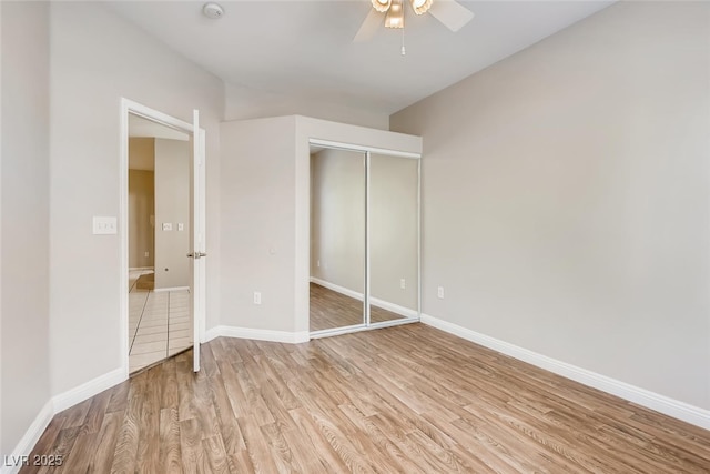 1713 Sky Of Red Dr Unit 203, Las Vegas, NV 89128 - unfurnished bedroom featuring light wood-type flooring, a closet, baseboards, and ceiling fan